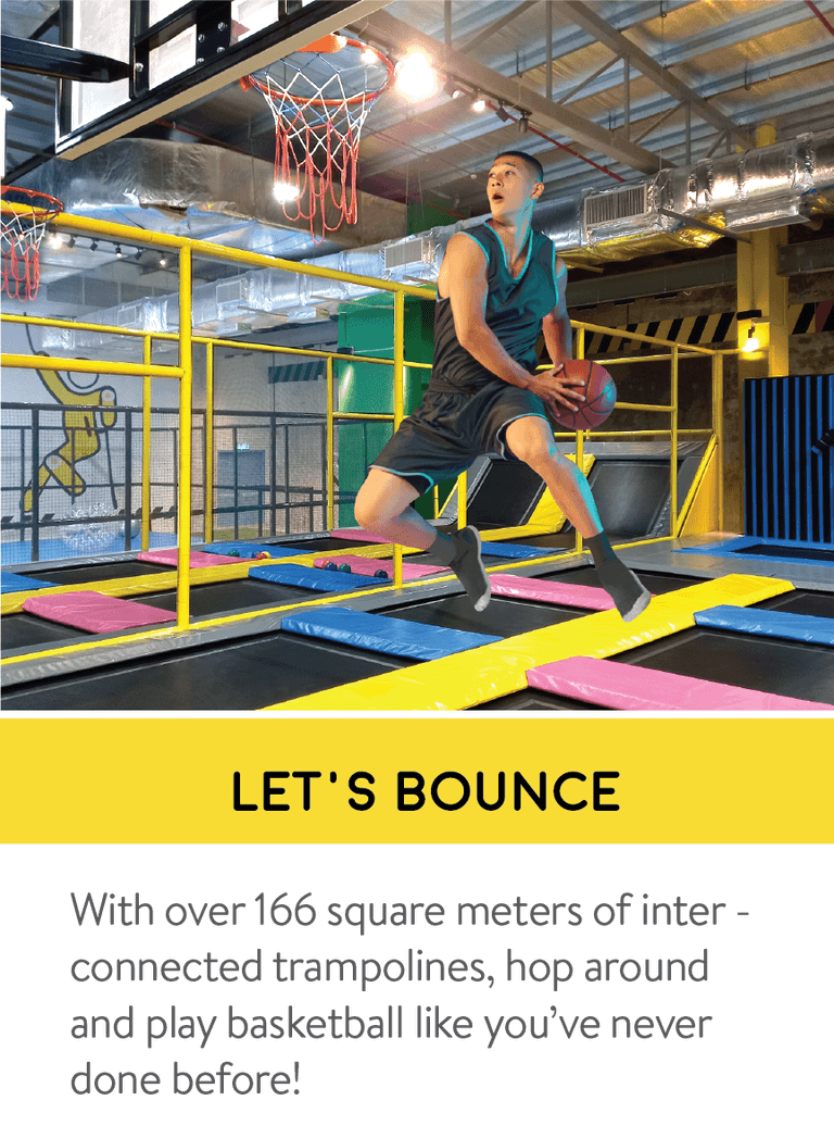 Visitor playing basketball on interconnected trampolines